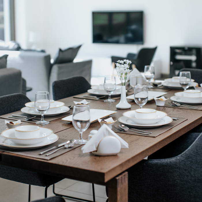 Dinner party table setting with dinnerware and servingware